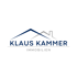 Logo: "Klaus Kammer Immobilien" unter einem stilisierten Dach in Blau und Grau.