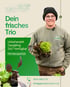 Lächelnder Mann in Mütze hält zwei Bündel Salat, Text "Dein frisches Trio" und Kontaktdaten.