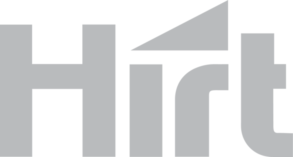 Hirt-Logo in Grau auf dunkelgrünem Hintergrund, wobei das "i" durch ein Dreieck ersetzt ist.
