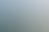Ein gelbes Gebäude mit einem runden Eckturm mit Kuppel und Bäumen davor.