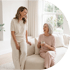 An older woman and a young woman talking happily