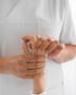 A medical professional examining a patient's wrist for arthritis.