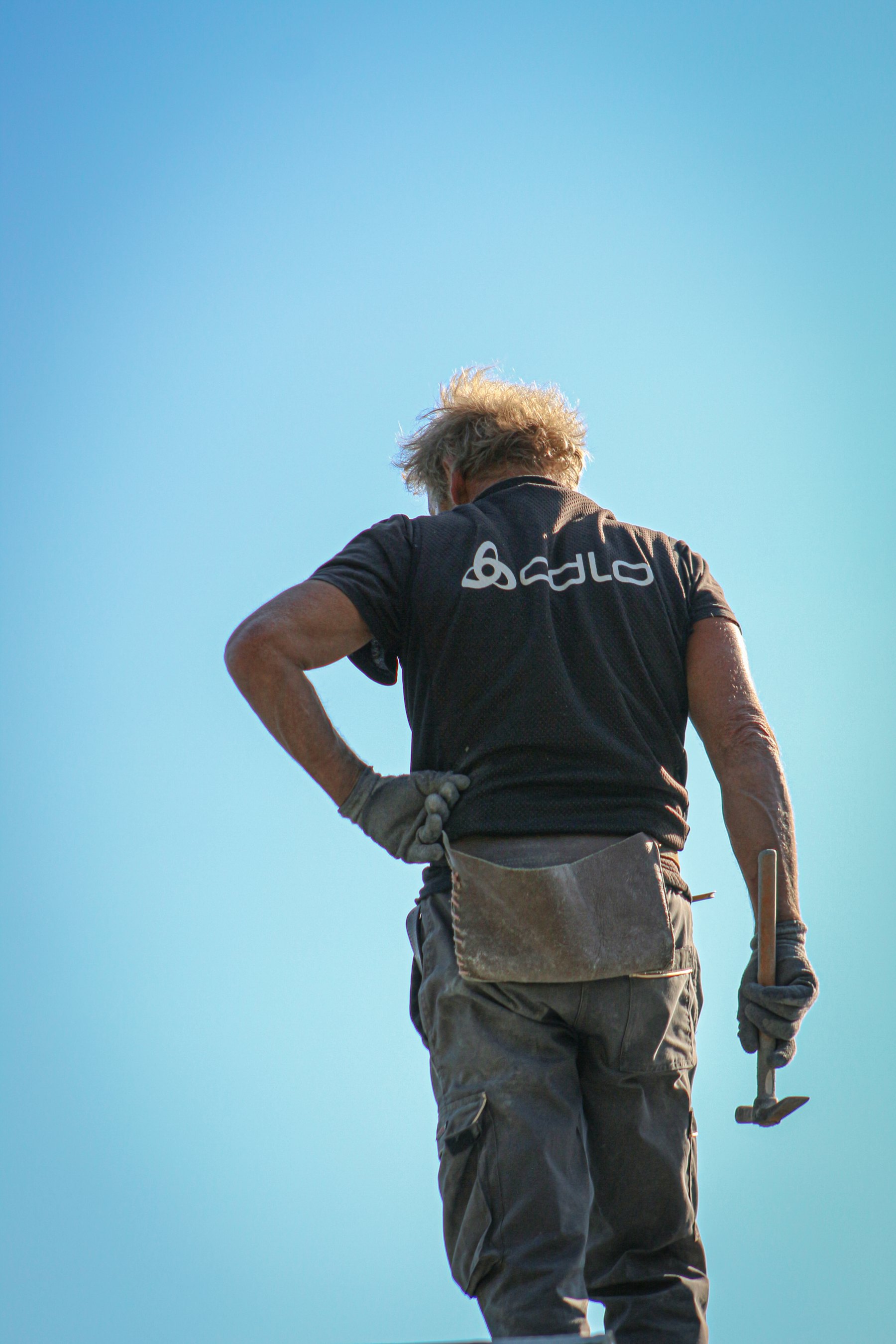 Roofing Aledo crew member on site under an open North Texas sky