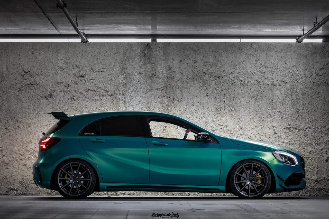 Turquoise hatchback with TEC Speedwheels GT 7 wheels in an underground car park