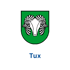 Grünes Wappen mit weißem Widderkopf und geschwungenen Hörnern; darunter der blaue Text "Tux".
