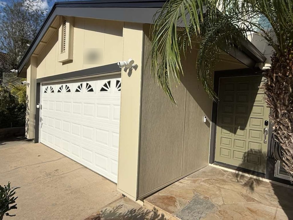 Garage and front entry finished in James Hardie Architectural Panel siding, Sea Grass texture, San Diego
