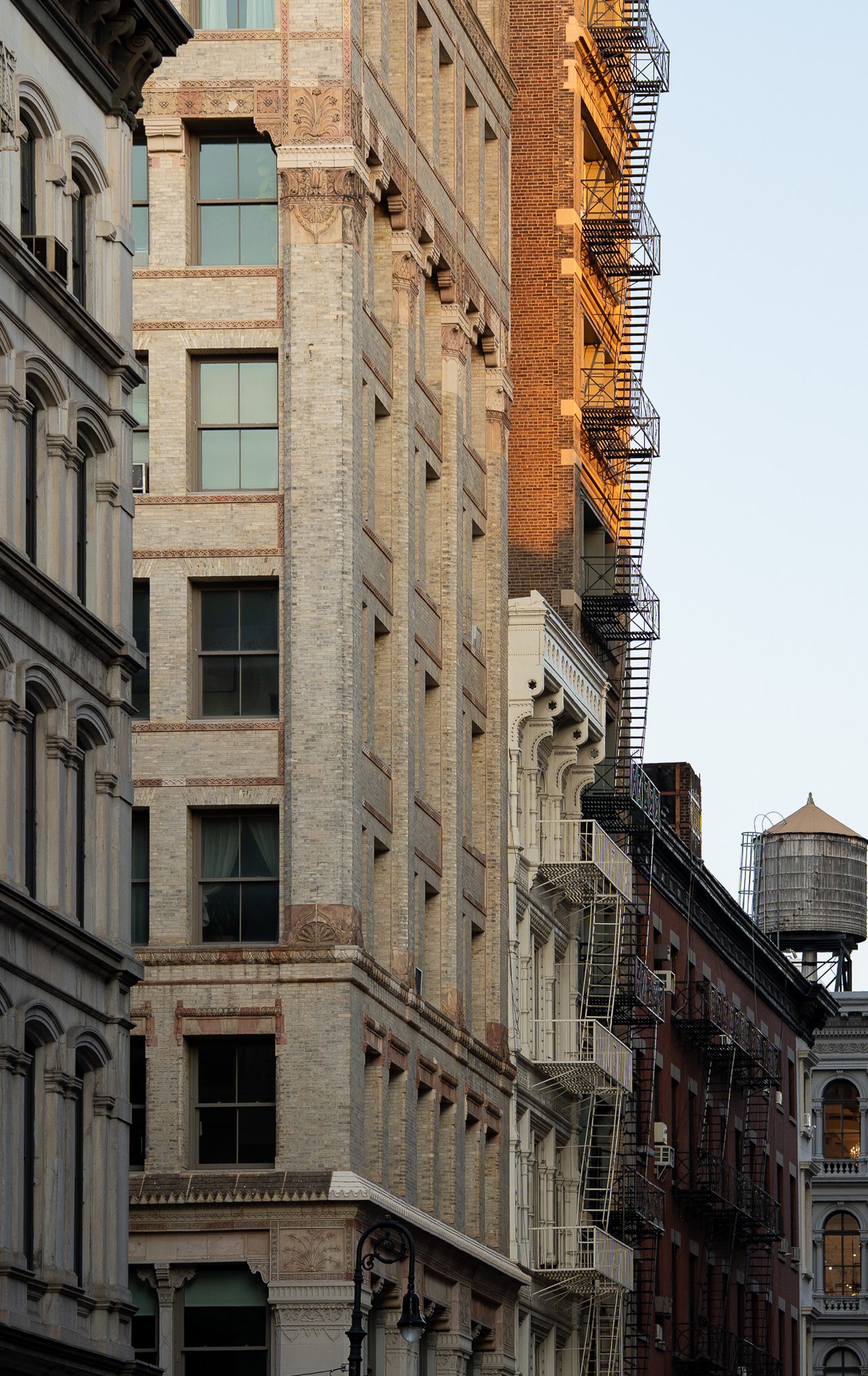 Cast-iron facades and a water tower in morning light, Lower Manhattan