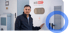 Mann in dunkler Jacke zeigt auf ein Energiespeichersystem mit der Aufschrift "HIS BATT STORAGE SYSTEM".