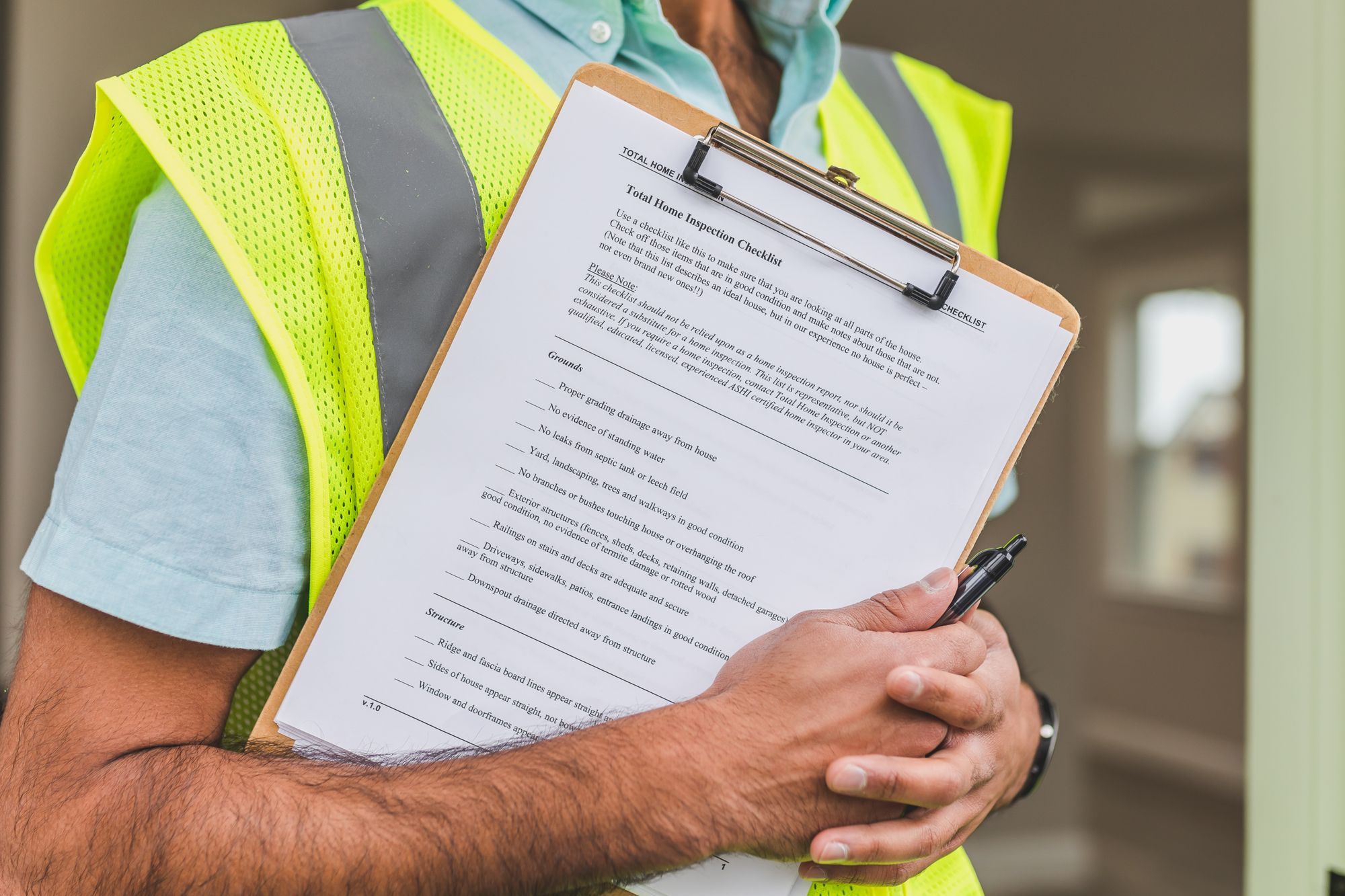 Inspector with a clipboard and checklist during a roof inspection on an Aledo, TX home