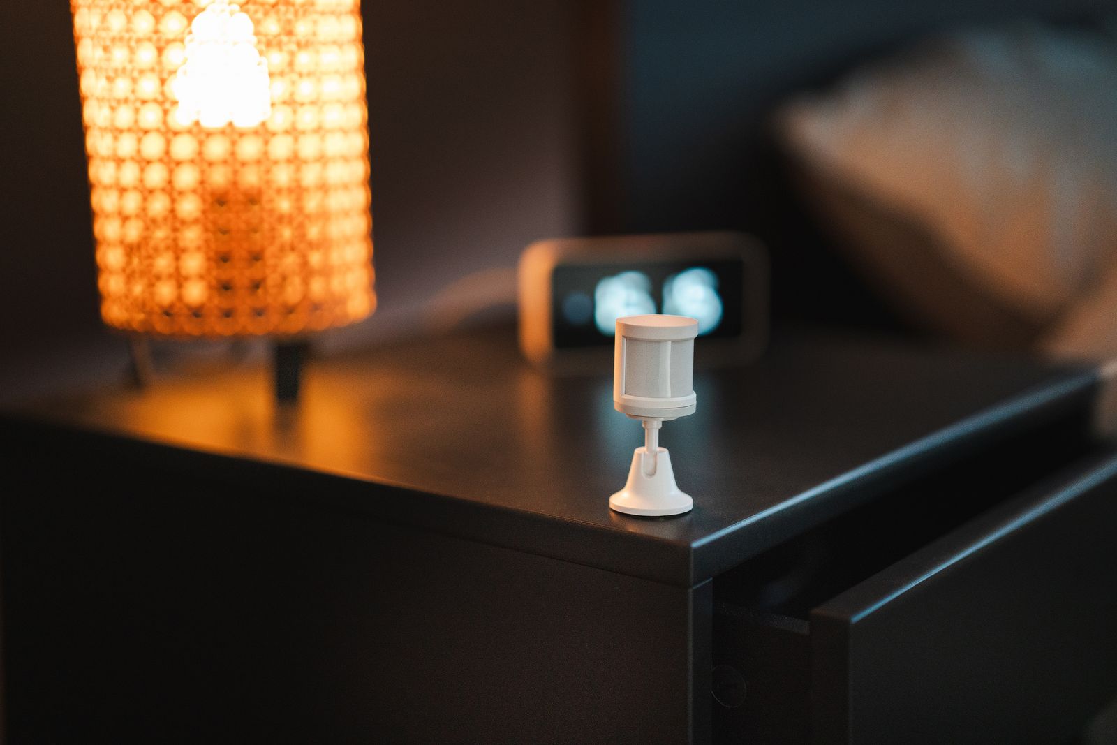A motion sensor mounted high on an interior wall