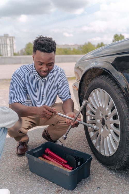 Checking your spare tire and fitting it with a wrench at the roadside near Hanford, California