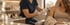 A clinician in blue scrubs and white gloves administers an injection into a woman's upper arm in a medical spa setting.
