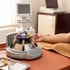 Blood samples in a laboratory centrifuge sit on a table next to a patient's arm during a medical procedure.