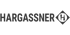 Hargassner Logo in Grau auf schwarzem Hintergrund mit dem Buchstaben H in einer Raute.