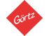 Rote Raute mit dem dunkelgrünen Schriftzug "Görtz" in geschwungener Schrift.