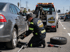 Towing Eastvale flat tire change service replacing a flat tire with professional roadside assistance on a busy roadway