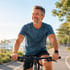 A gray-haired man cycling, energized after low testosterone treatment.
