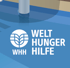 Logo von Welthungerhilfe mit stilisierten Ähren und dem Text "WELT HUNGER HILFE WHH" auf blauem Hintergrund.