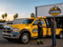 Towing Eastvale technician greeting a customer beside a tow truck before providing professional towing service