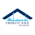 Logo mit Düsseldorfer Skyline, Rheinturm und Brücke, umrahmt von einem dunkelblauen Hausdach; darunter "IMMOCARE AM RHEIN".
