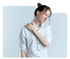 Woman experiencing shoulder pain, grabbing her shoulder with her hand.