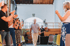 Man walks down aisle as people clap in a large, bright room with high ceilings.
