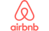 Rotes Airbnb-Logo mit dem A-förmigen Bélo-Symbol über dem Schriftzug „airbnb“.