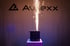 A black spark machine on a white pedestal emits golden sparks upwards, with a backlit "AVEXX" logo.
