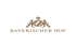 Braunes Logo "BAYERISCHER HOF" mit Wappen: Krone über bayerischem Rautenmuster, flankiert von zwei Löwen.