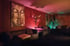 Gemütlicher Lounge-Bereich mit Buddha-Gemälde und stimmungsvoller Beleuchtung im Swingerclub Angel of Fantasy.