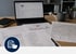 Digitalisierung von Papierdokumenten wie Karten und Listen in eine Software-Anwendung auf einem Laptop am Schreibtisch - Software für Alarmierung - Notfall- und Krisenmanager (NKM®).