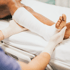 Leg bandaging on bed, illustrating work injury treatment and care.
