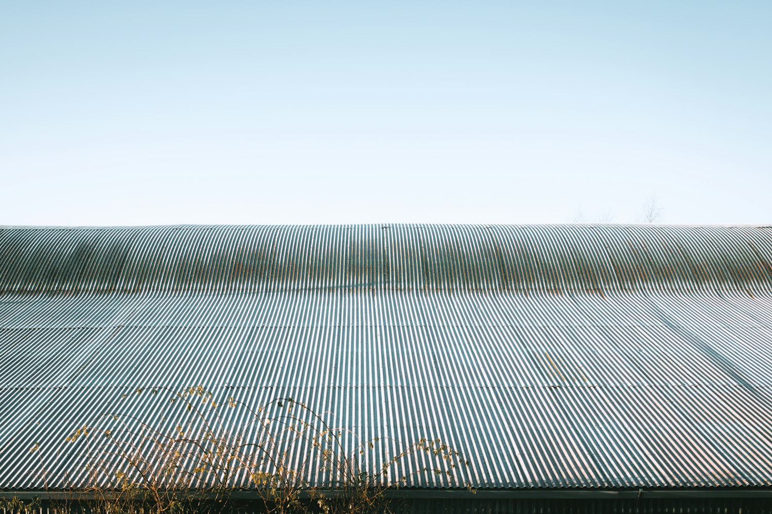 Standing seam metal roof panels under a clear sky