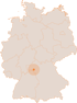 Landkarte von Deutschland mit Bundesländern und einer orangefarbenen Markierung im Bereich Nordbayern und Südhessen.