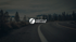 Logo von Instyle Moving über einer Straße und bewaldeten Bergen.