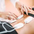  practitioner applying electrodes for E-stim therapy to a patient's torso