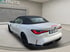 Weißer BMW M4 Cabrio von hinten rechts mit schwarzem Verdeck und Kennzeichen "MM HT 2".