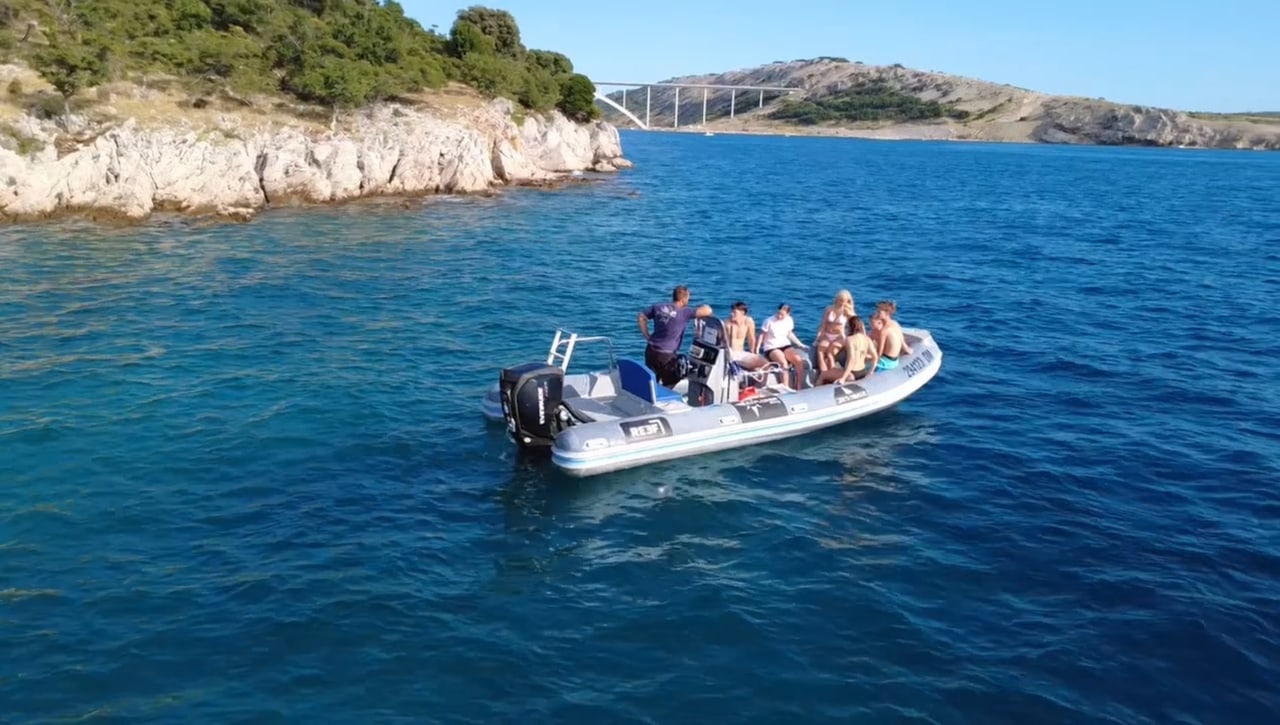 The dive boat with a group of guests out on the clear blue bay