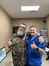 Two men give thumbs up.