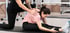 Physical therapist guides woman in hamstring stretch for disc relief