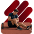 Man on a red track holds his knee, seeking sports injury treatment.