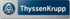 ThyssenKrupp-Logo mit blauem Kreis und stilisiertem Emblem links, daneben weißer Text "ThyssenKrupp" auf blauem Feld.