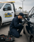 Towing Port Charlotte lockout service technician unlocking a vehicle door during roadside assistance.