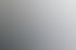 Eine blonde Frau in blauer Strickjacke und weißem Oberteil sitzt und hält ein offenes Notizbuch.