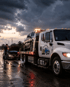 owing Port Charlotte emergency roadside towing service recovering a pickup truck during rainy weather.
