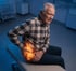 Elderly man grimacing, holding his hip while seeking relief from hip pain