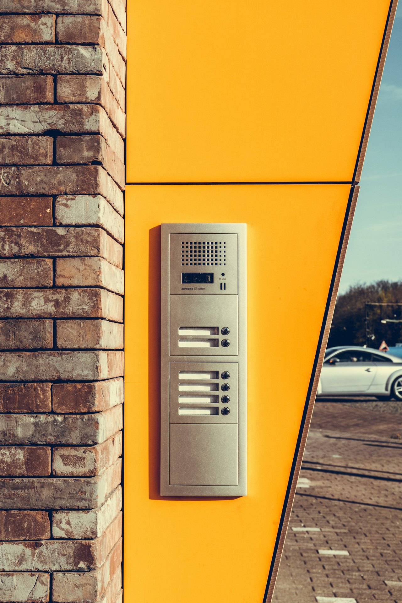 A wall-mounted alarm system unit reporting to a monitoring station