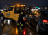 Towing Eastvale roadside towing service loading a disabled car onto a tow truck during a rainy night emergency
