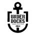 Schwarzer Anker mit dem Text "UNDER DOCKS URBAN FISH FOOD" und einem Fischsymbol.