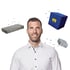 Man in white shirt smiling, with a grey paver block, a grey concrete block, and a blue cube with a yellow "m".